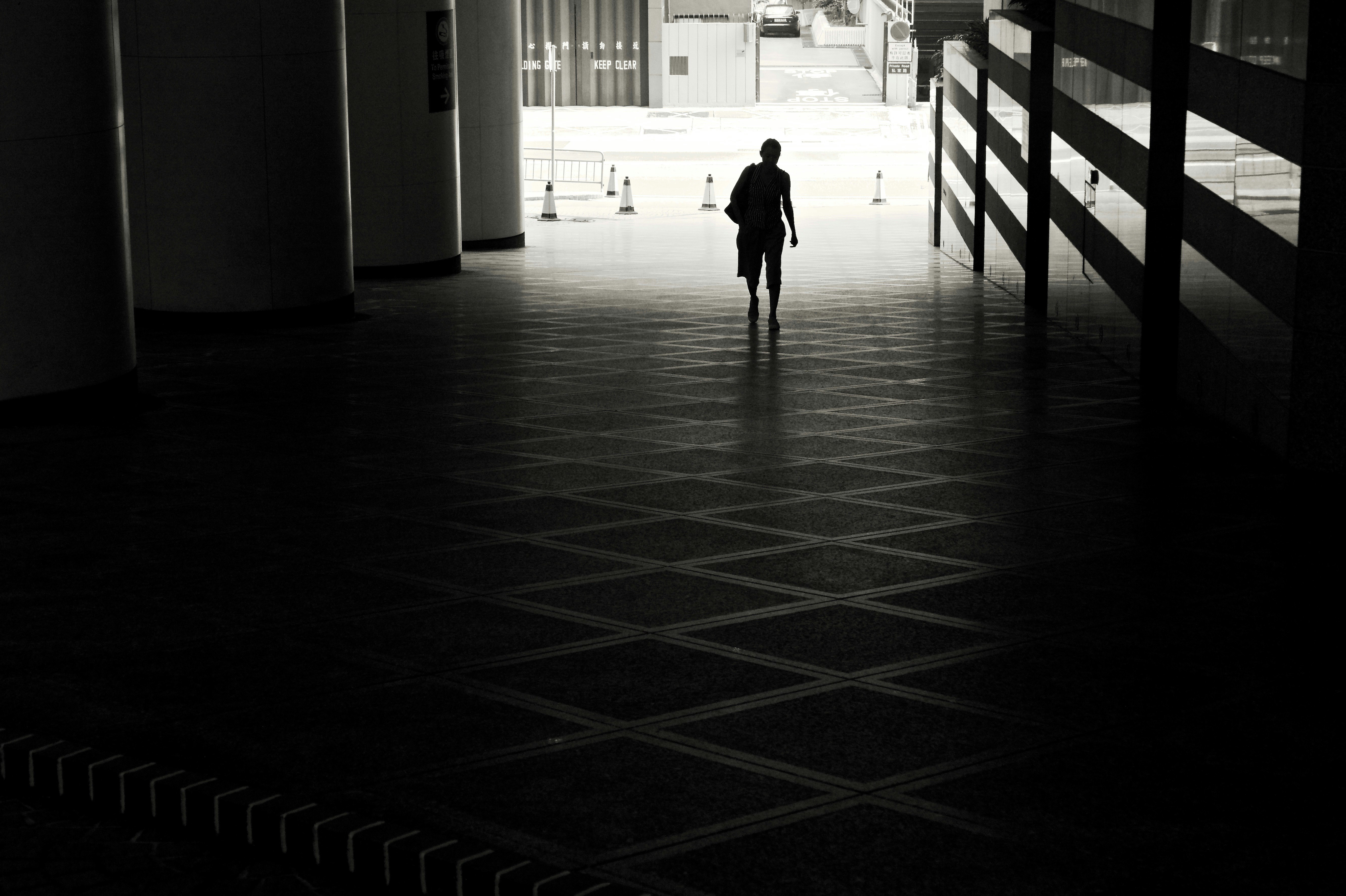 man walking on hallway taken during daytime